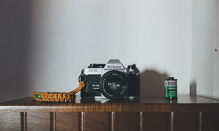 A Nikon camera placed on a shelf - different types of cameras